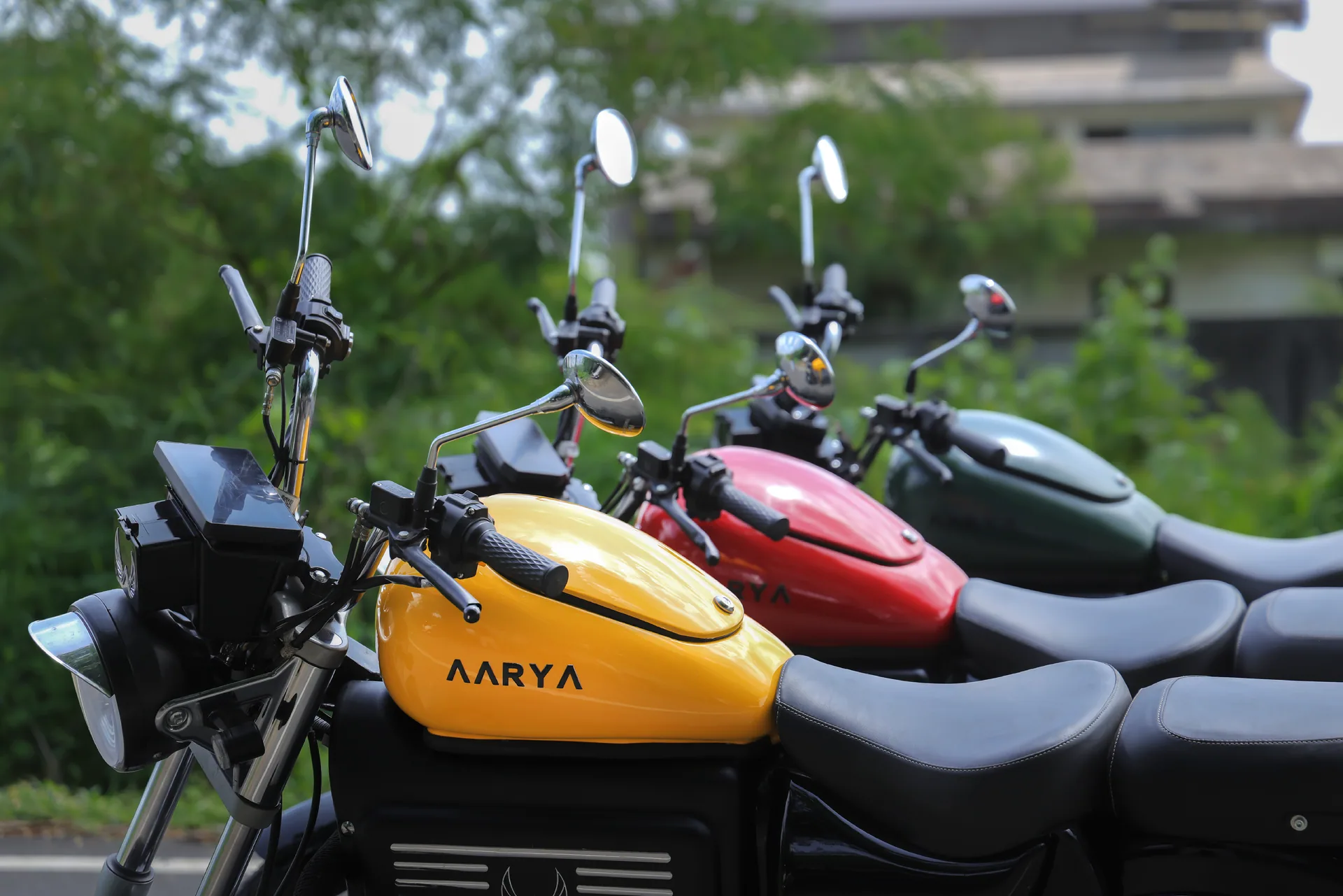 Digital display pods and bar-end mirrors on three Aarya Commander motorcycles